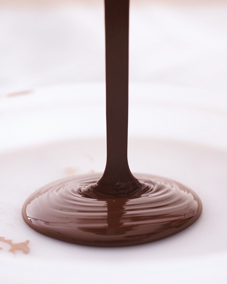 Chocolate being poured onto a plate