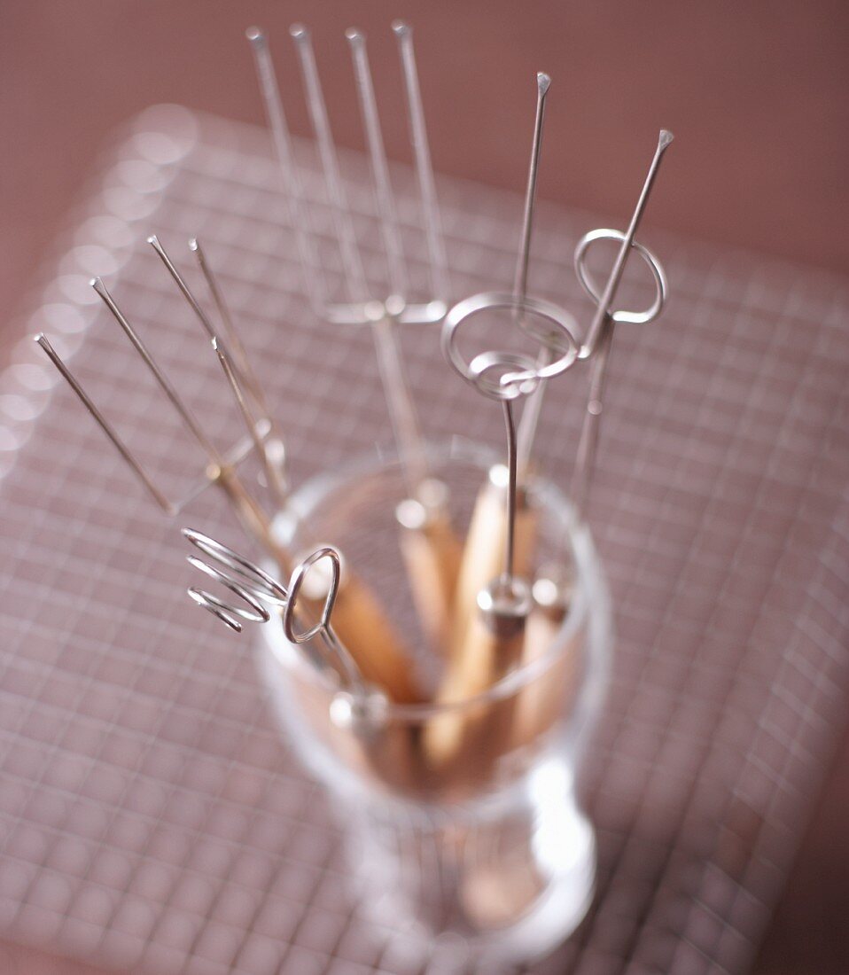 Various praline forks in a glass