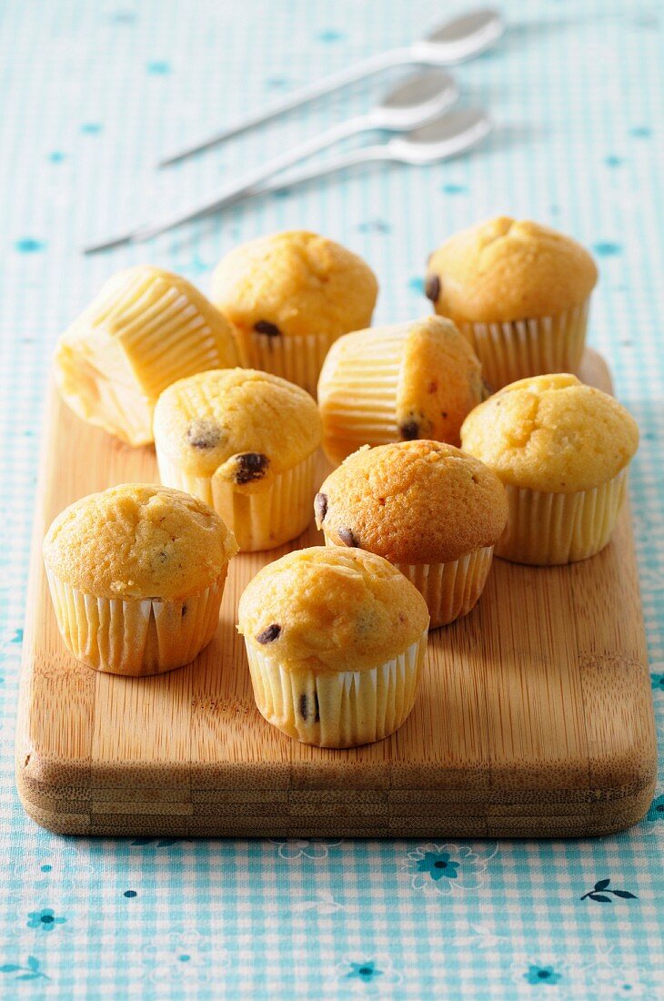Chocolate chip muffins on a chopping board