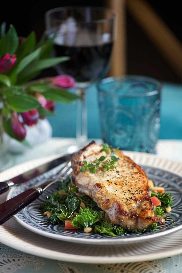 A pork chop with kale