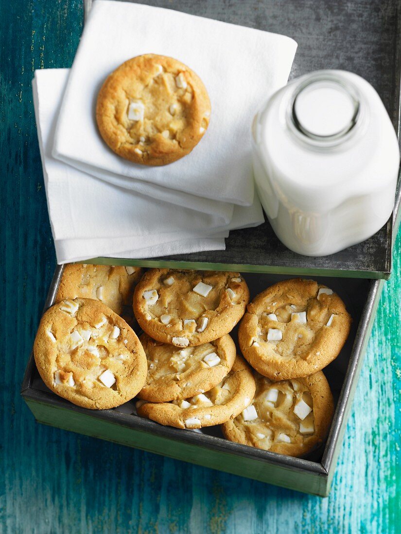 White chocolate chip cookies and a bottle of milk