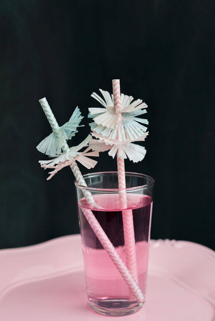 Strohhalme mit Manschetten in rosa Getränk