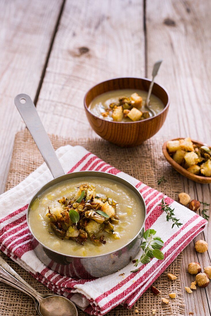 Hearty winter soup with roasted artichokes, hazelnuts and croutons