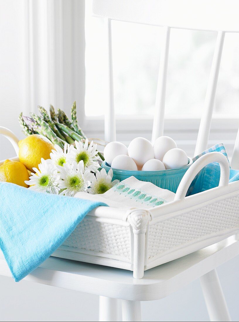 Eggs, asparagus, and lemons in basket