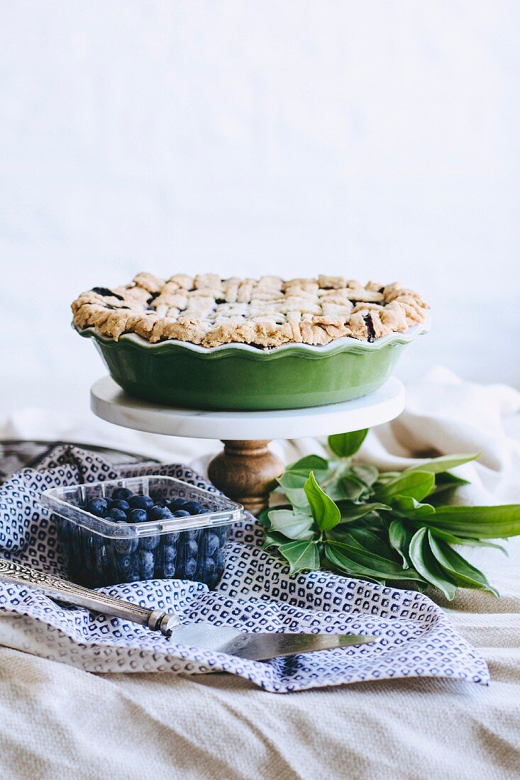 A blueberry pie on a platter