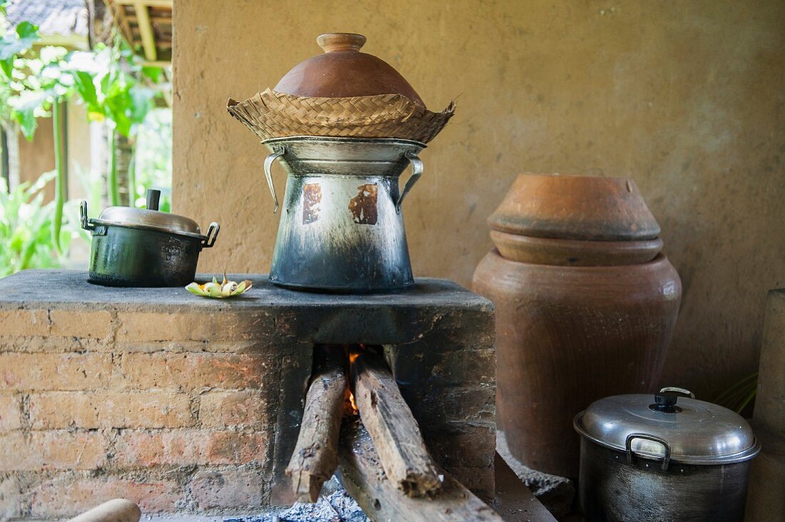 Pots over a wood-fired oven in an outdoor kitchen