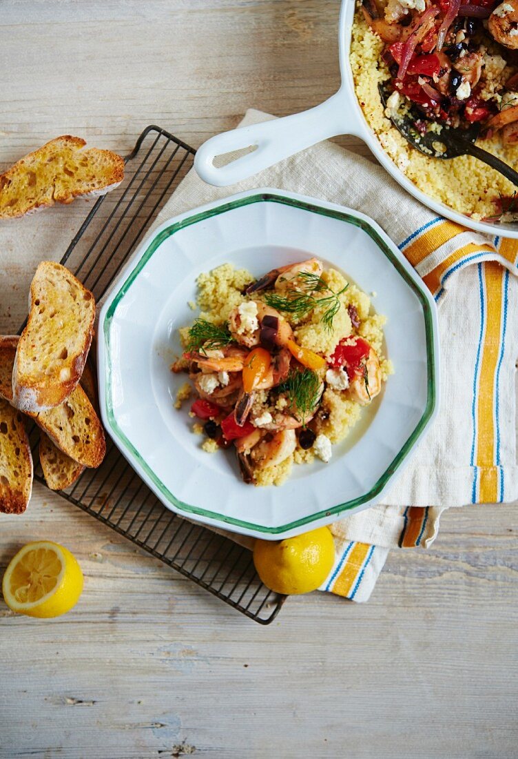 Prawn Saganaki with tomatoes, feta cheese, olives and couscous (Greece)