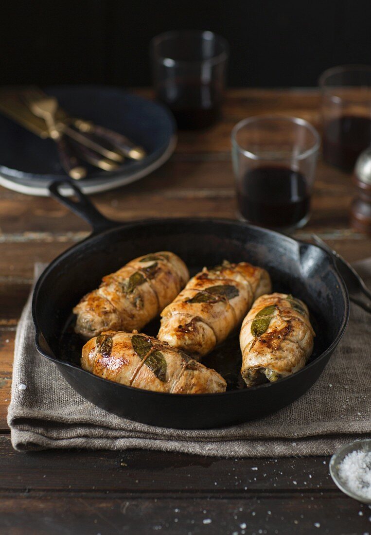 Stuffed chicken breast with sage in a pan