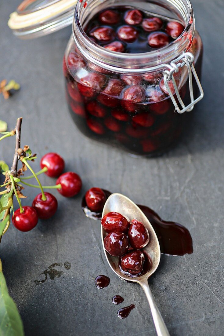 Preserved sour cherries on a slate surface