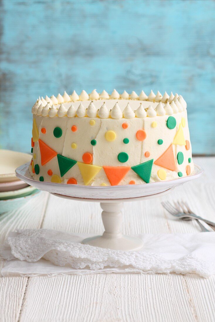 Berry mousse cake decorated with colourful confetti decorations