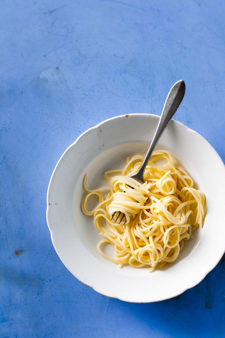 Cooked linguine on a plate with a fork