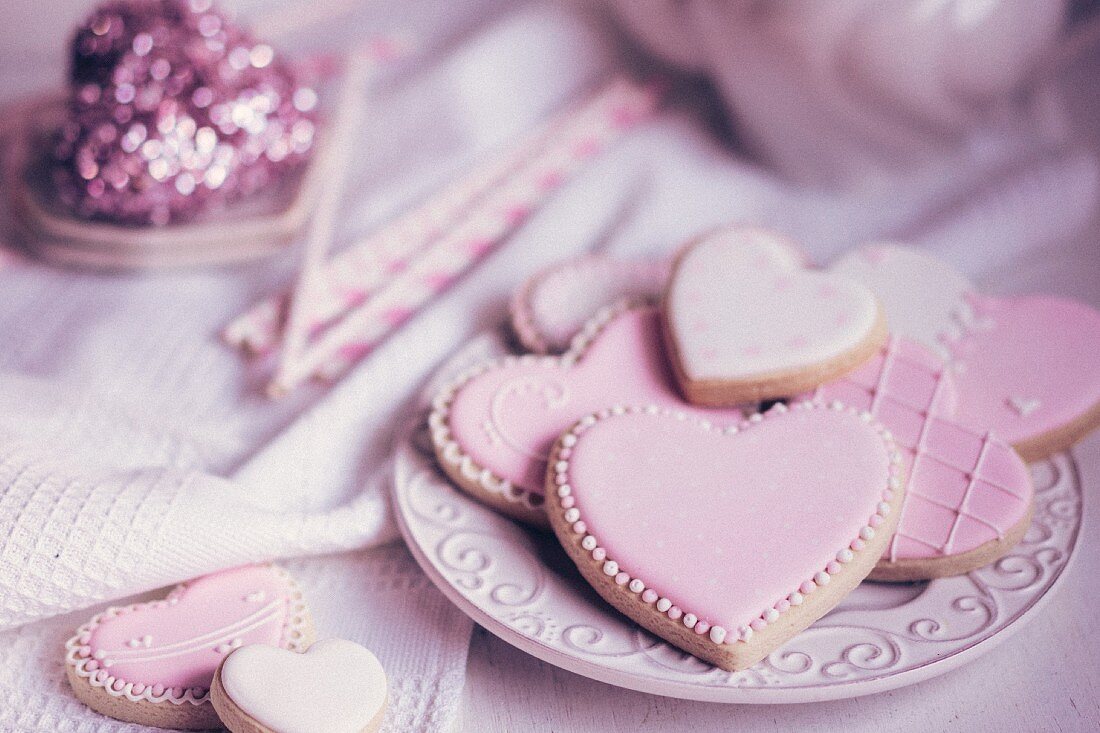 Pastel coloured heart-shaped biscuits on a plate