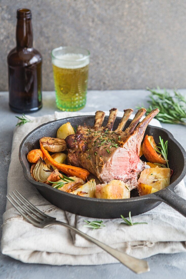 Saddle of lamb with roasted vegetables served with a beer