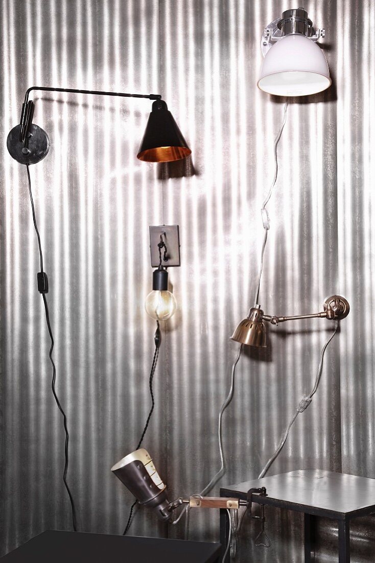 Various wall-mounted lamps and clip lamps on silver background