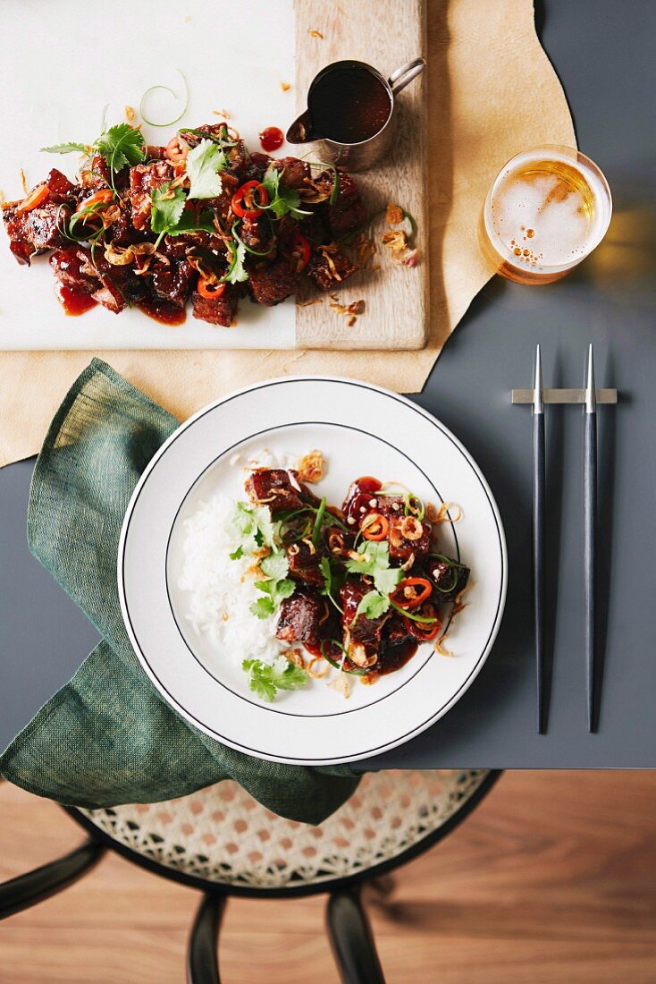Sweet and sour pork with coriander on rice