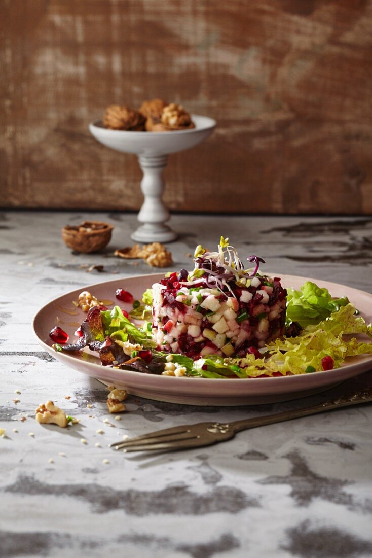 Oak leaf lettuce with horseradish sprouts and beetroot and apple tatar in a grapefruit and walnut marinade