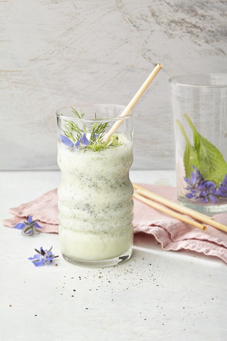 Cucumber drink with almond milk, limes, dill and borage flowers