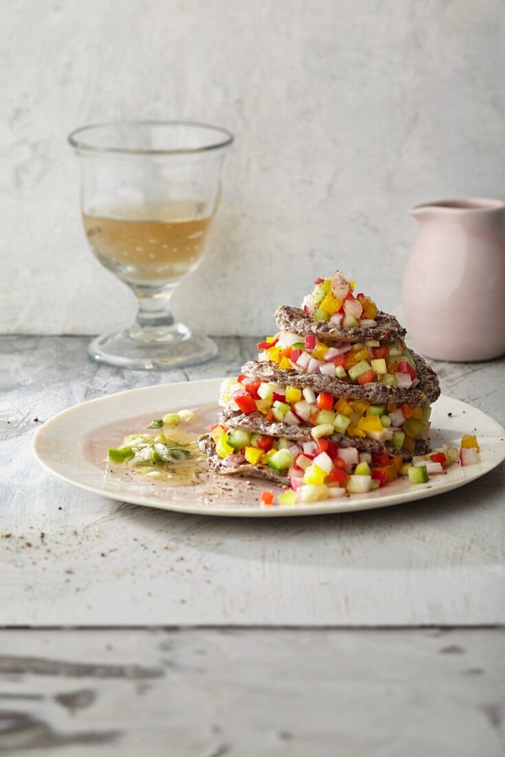 Colourful vegetable salad in a rape seed oil marinade with crispy flaxseed wafers