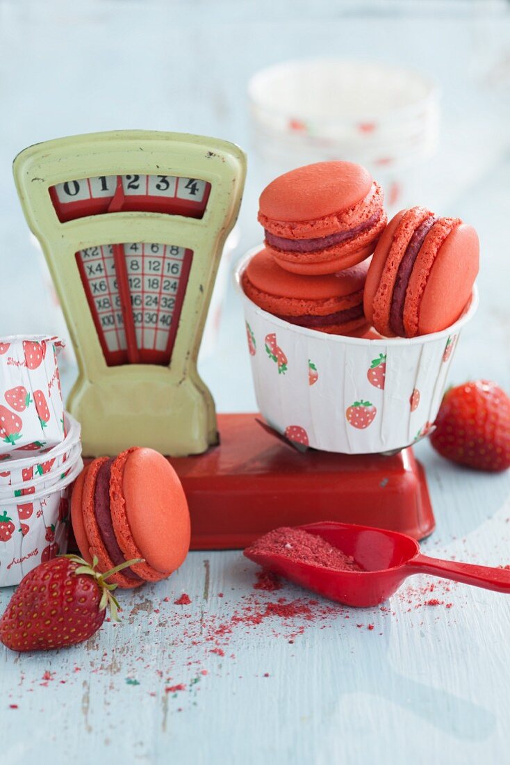 Strawberry macaroons on a pair of old toy scales