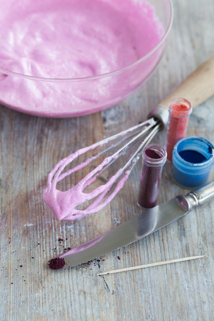 Pink beaten egg whites, food colouring and a whisk