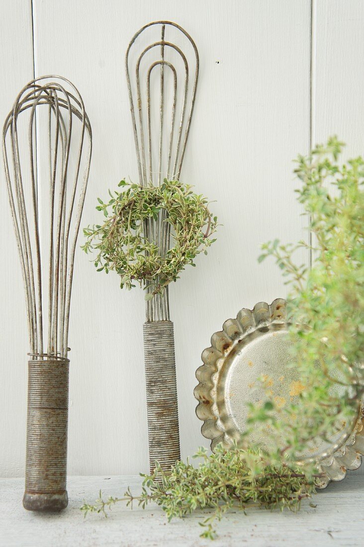 Kitchen utensils with a wreath of thyme
