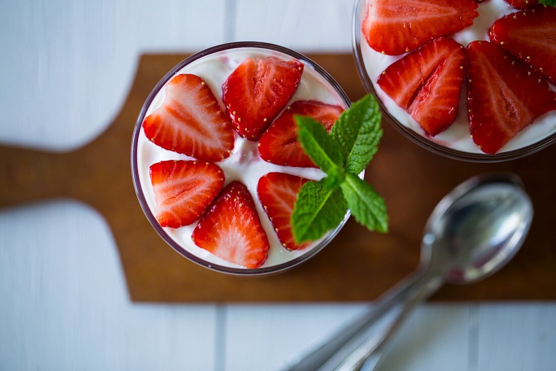 Layered strawberry deserts in glasses