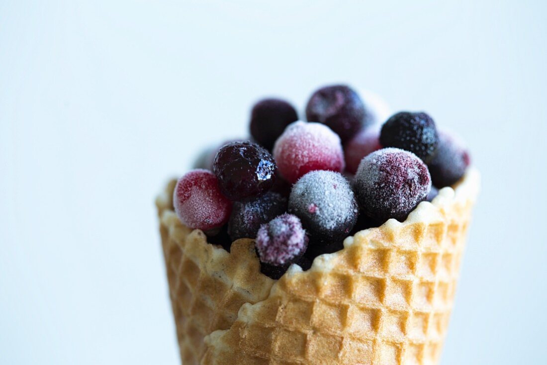 Frozen wild berries in an ice cream cone