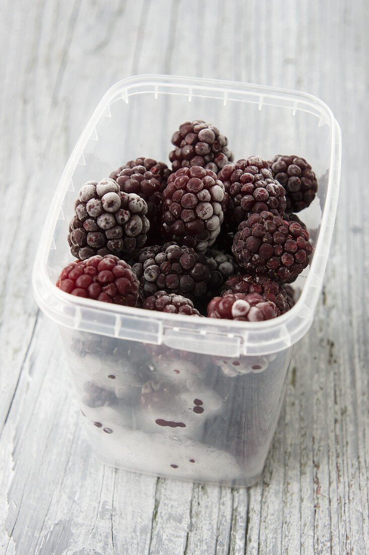 Frozen blackberries in a plastic container