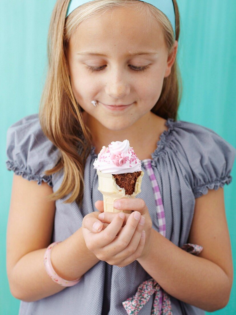 Girl holding ice-cream cone cupcakes