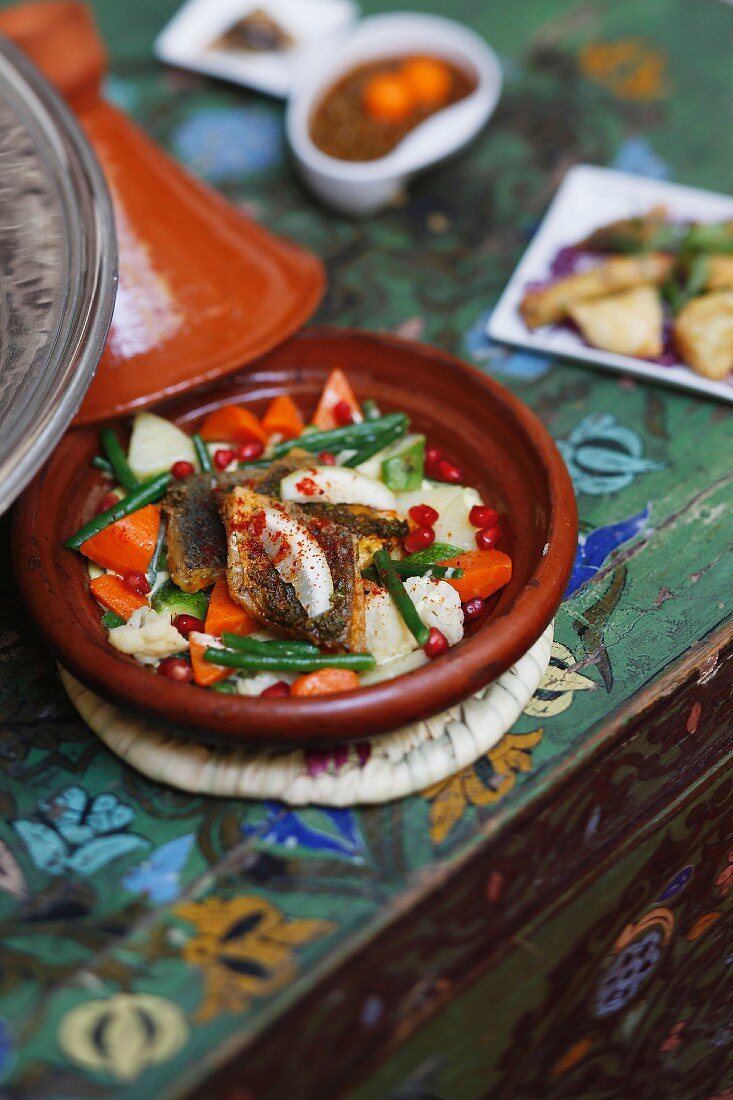 Fish tagine with vegetables and pomegranate seeds, Marrakesh, Morocco