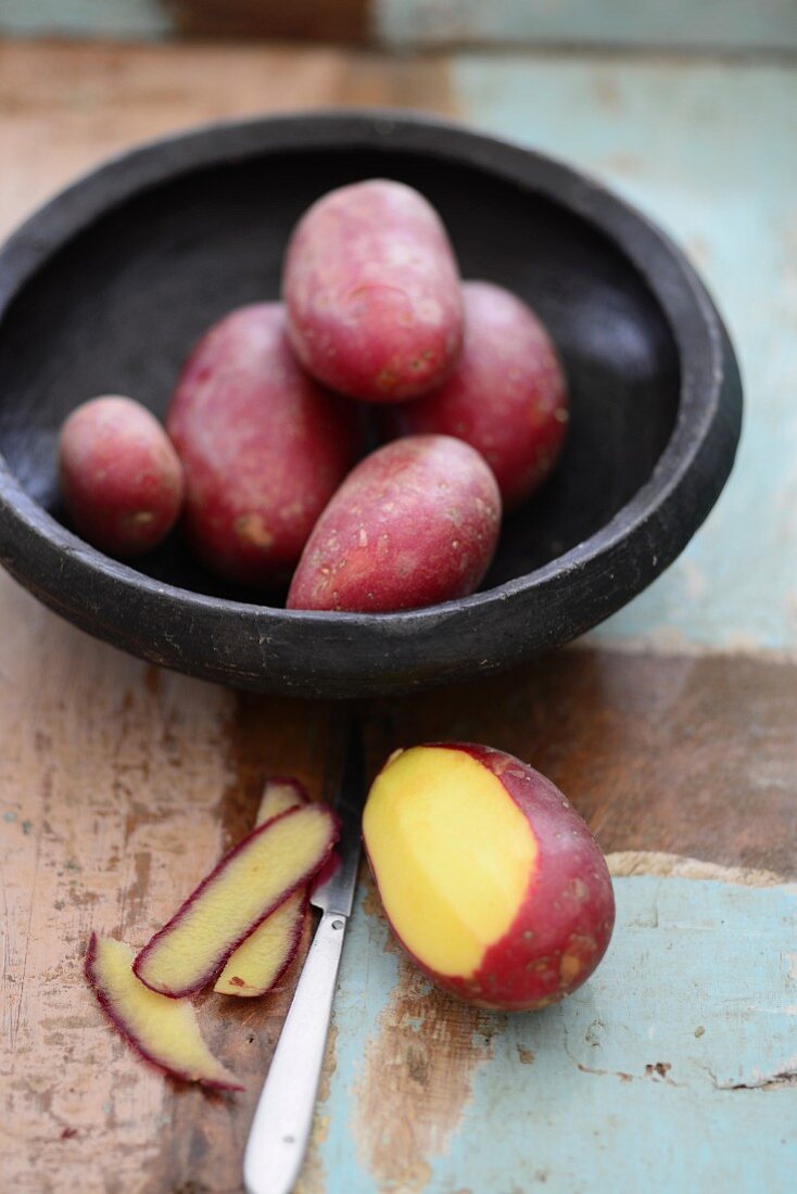 Red potatoes, one partially peeled