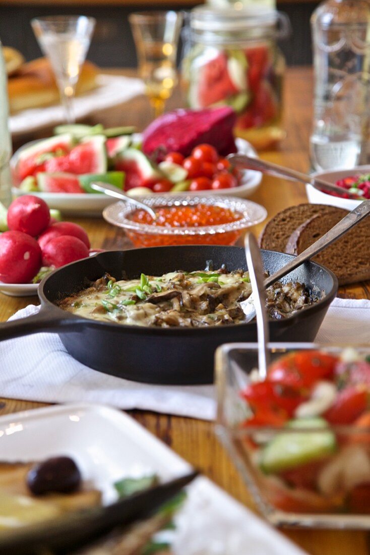 Gedeckter Tisch aus Russland mit eingelegtem Gemüse, Pilzen und Wodka