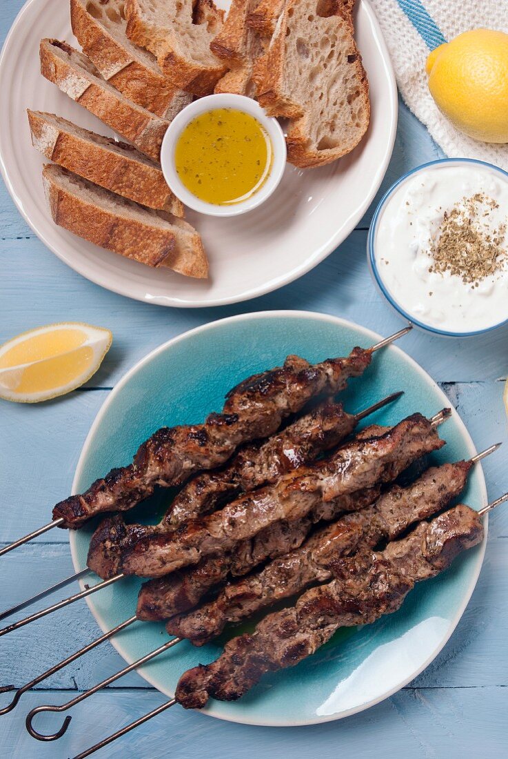 Pork souvlaki kebabs served with tzatziki and bread