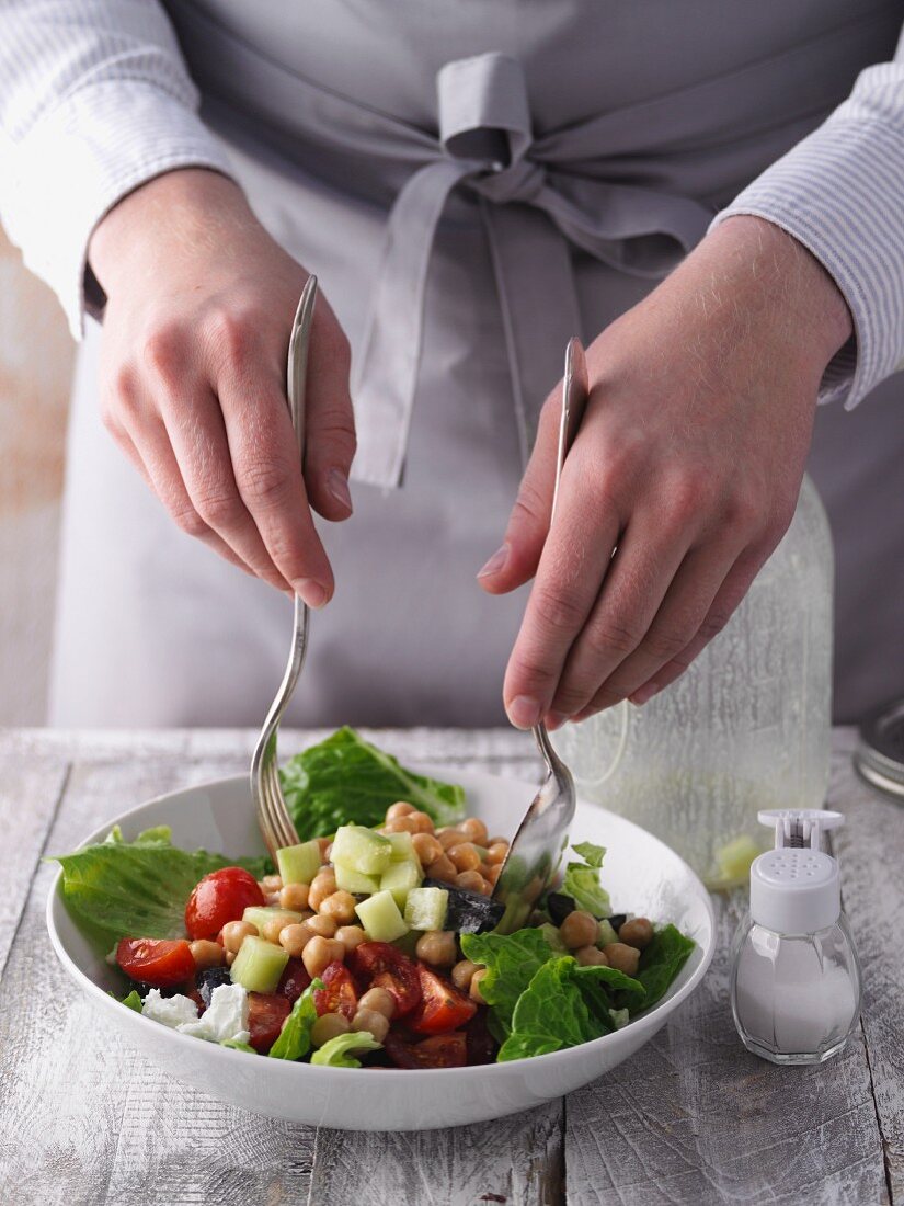 Greek salad being mixed