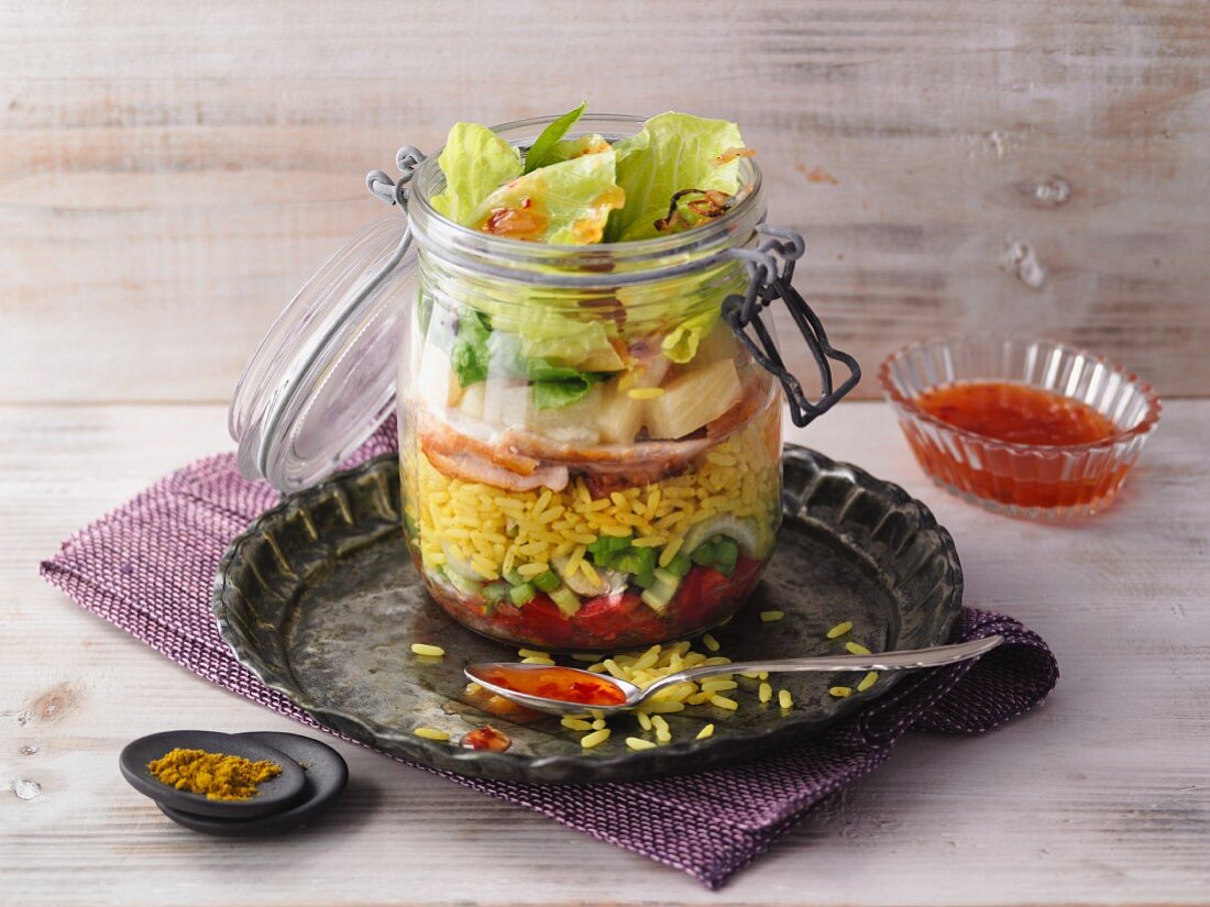 Layered curry rice salad with chicken in a jar