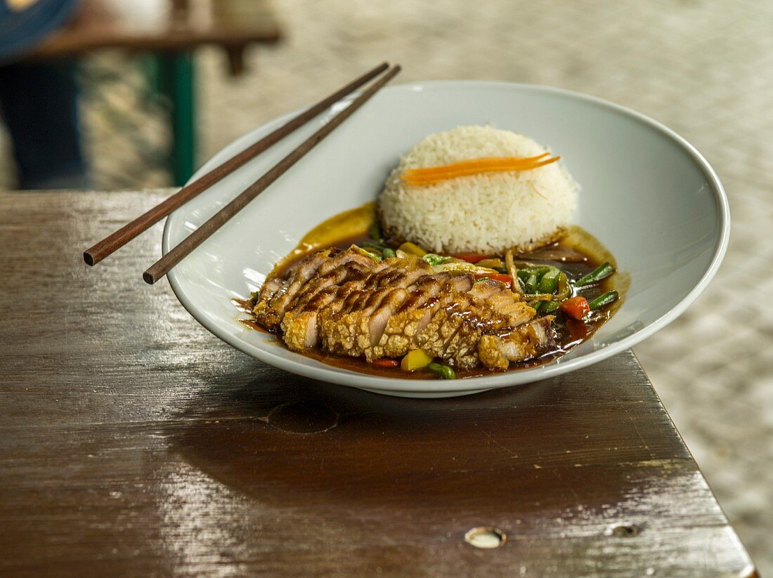 Fried pork belly with a side of rice