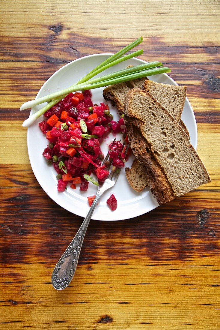 Russian beetroot salad with country bread and spring onions