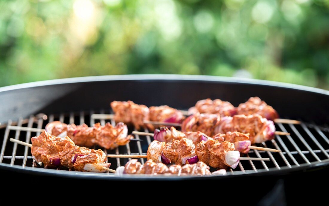 Tandoori chicken skewers on a barbecue