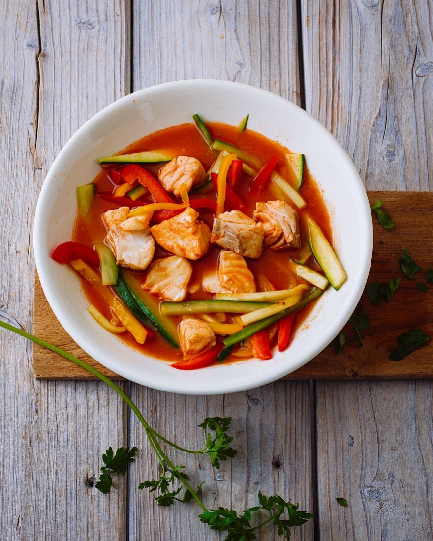 Tomato and fish goulash with peppers, cucumber and courgette