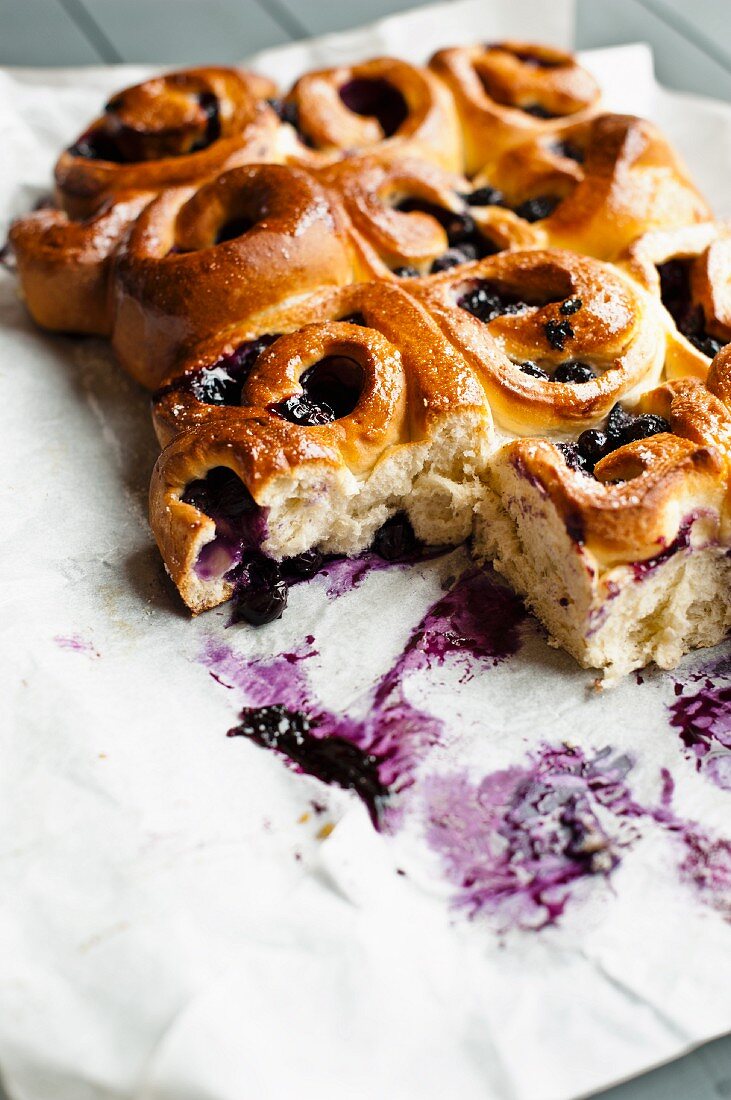 Blueberry rolls on a piece of white parchment paper