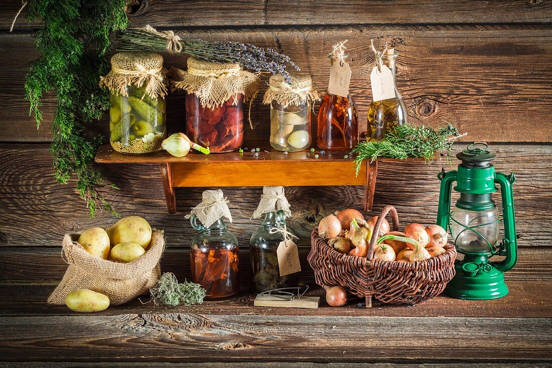 Various preserved vegetables and mushrooms on a wooden shelf