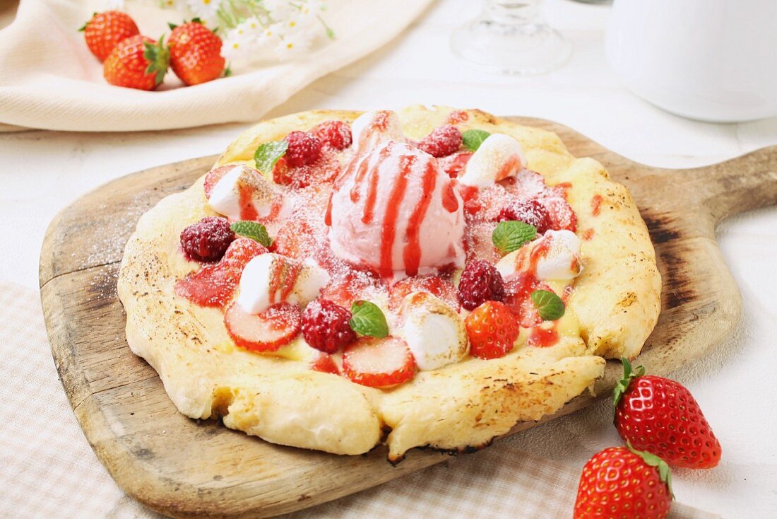 A sweet pizza with strawberries and strawberry ice cream