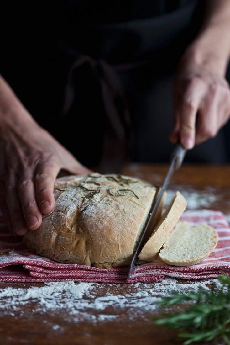 Freshly baked bread being cut