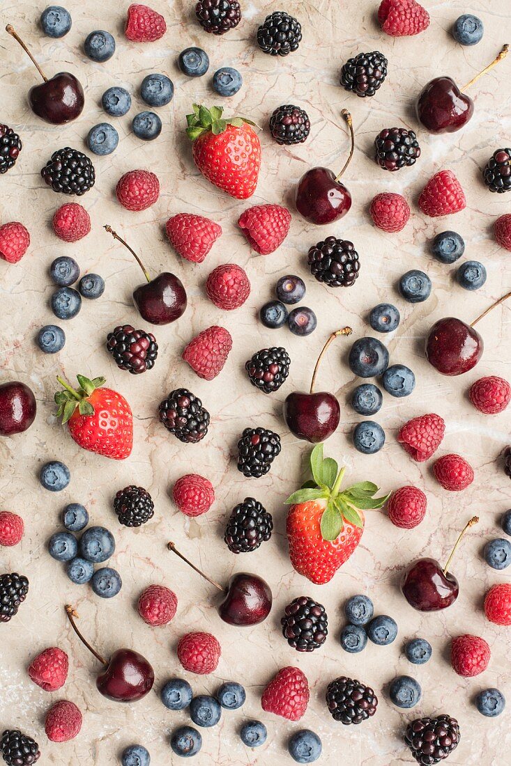 Various fresh berries and cherries (seen from above)