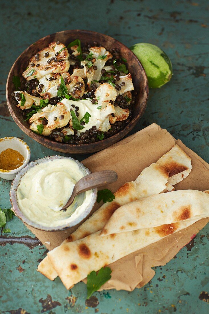 Roasted cauliflower salad with beluga lentils and spicy yoghurt