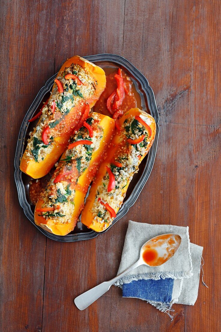 Winter squash stuffed with couscous, peppers, spinach and gorgonzola