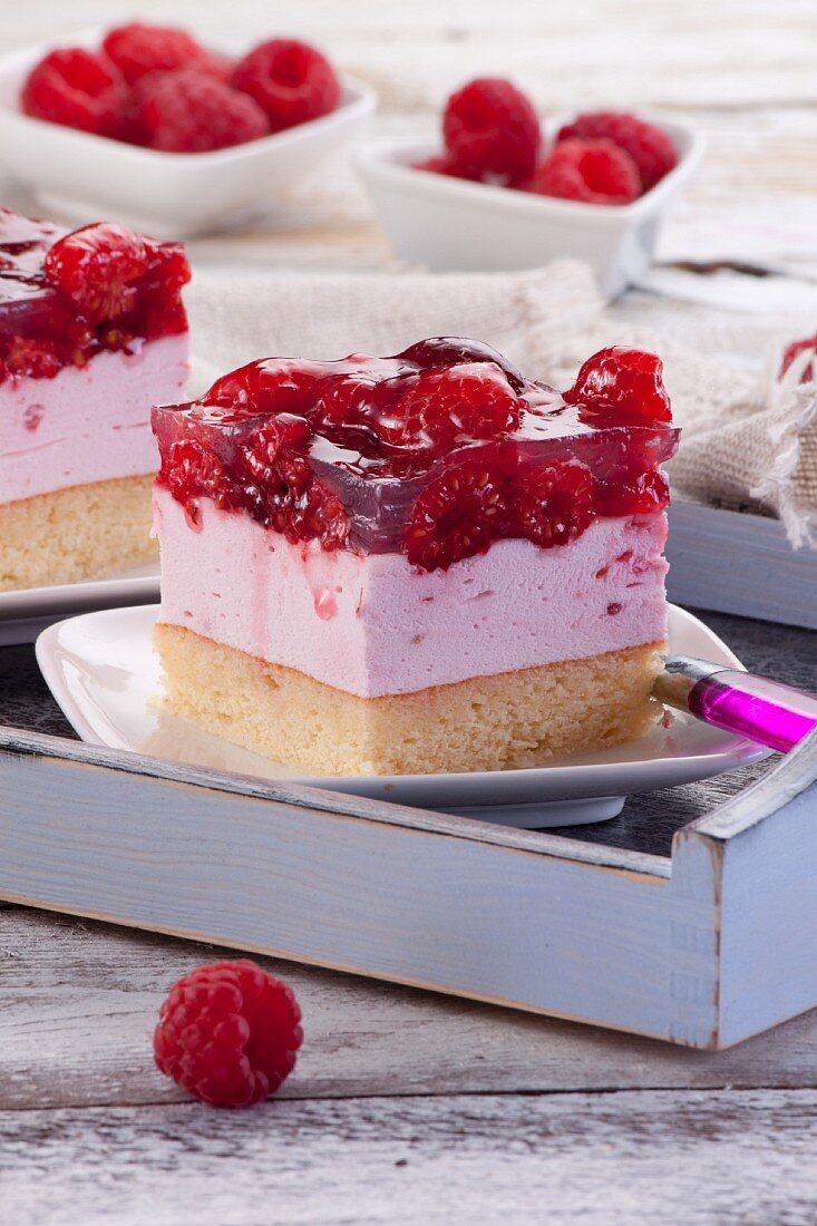 A slice of raspberry cheesecake with raspberry jelly