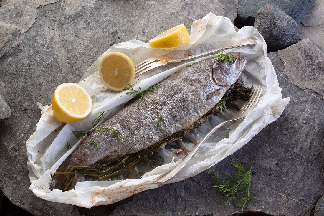 Roasted whole trout with dill and lemon in parchment paper