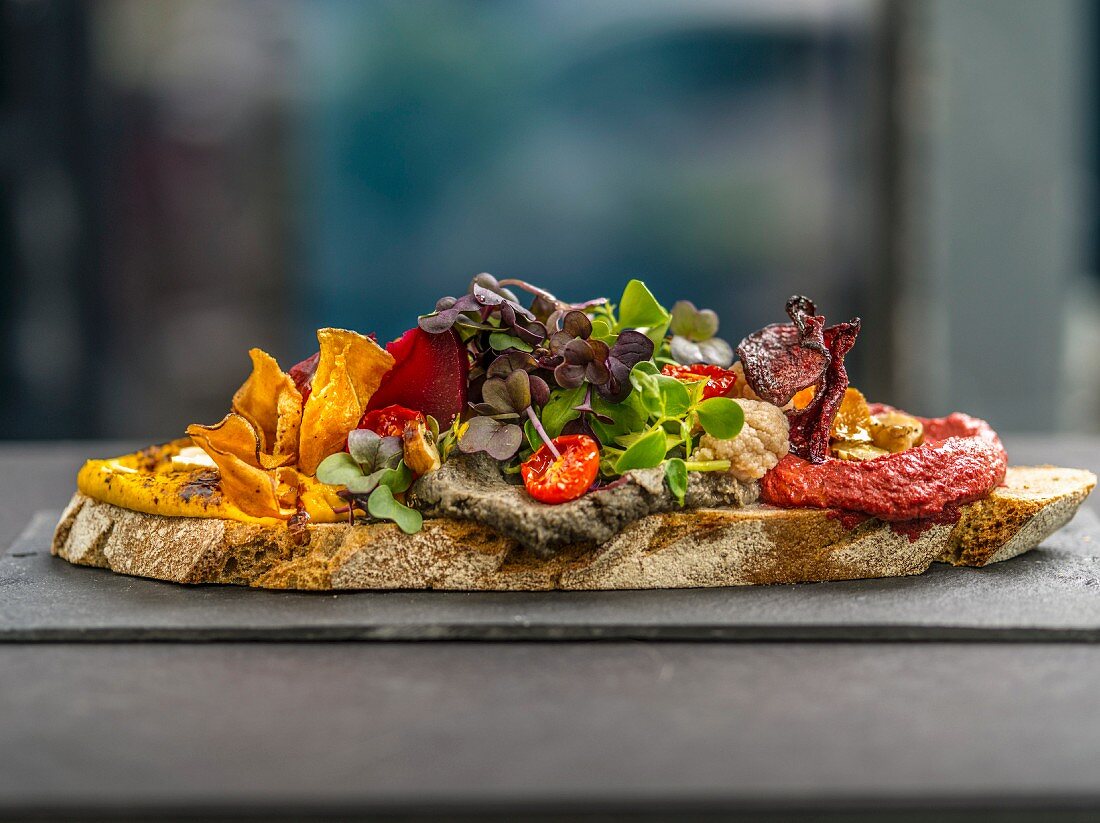 Belegtes Brot mit Aufstrichen, Gemüsechips und Kresse