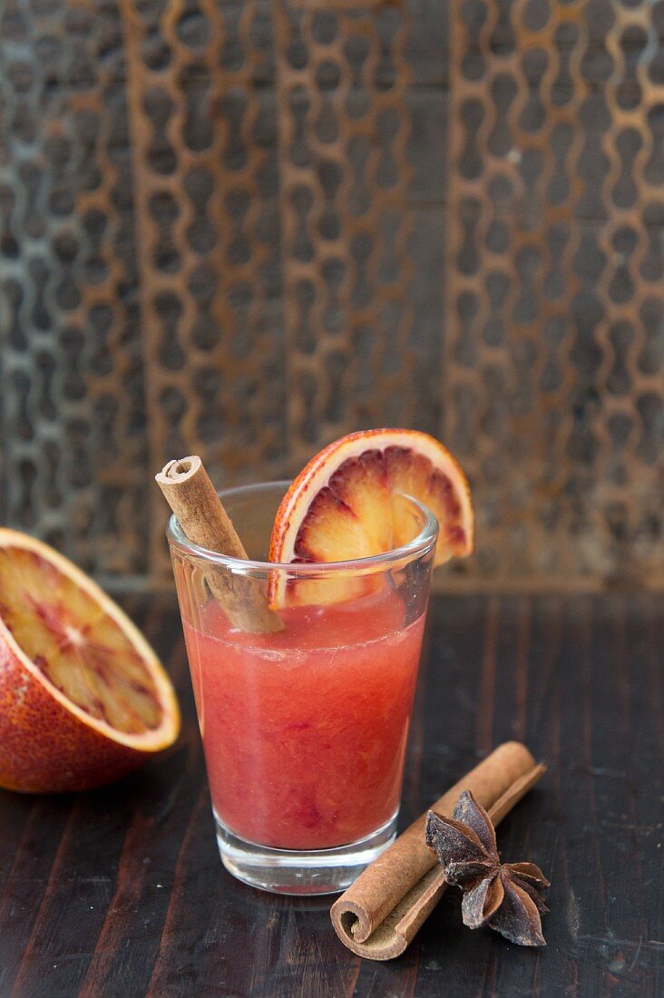 Blood orange juice with cinnamon sticks